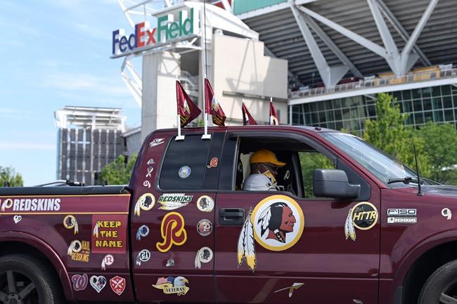 Rodney Johnson of Chesapeake, Va., sits in his truck outside FedEx Field in Landover, Md., Monday, July 13, 2020. The Washington NFL franchise announced Monday that it will drop the