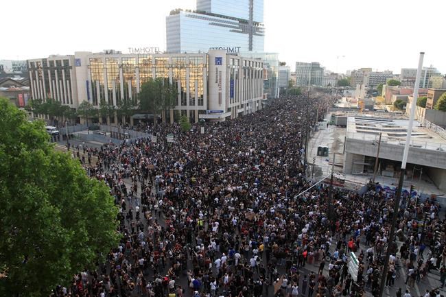 Protesters gather Tuesday, June 2, 2020 in Paris. Thousands of people defied a police ban and converged on the main Paris courthouse for a demonstration to show solidarity with U.S. protesters and denounce the death of a black man in French police custody. The demonstration was organized to honor Frenchman Adama Traore, who died shortly after his arrest in 2016, and in solidarity with Americans demonstrating against George Floyd's death. (AP Photo/Michel Euler)