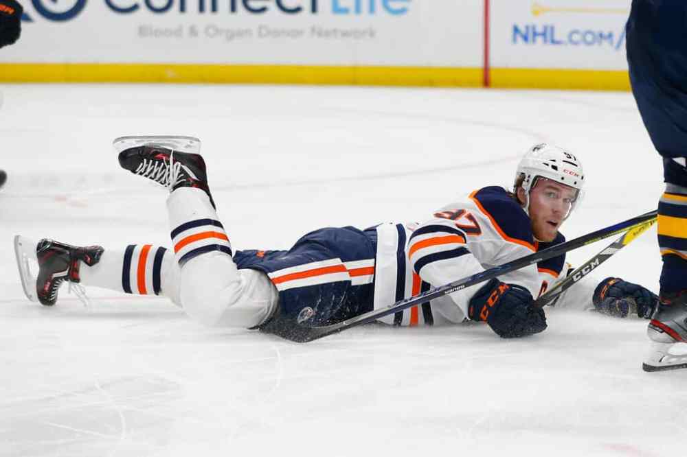 CP
Edmonton Oilers forward Connor McDavid lies on the ice after being tripped. (AP Photo/Jeffrey T. Barnes)