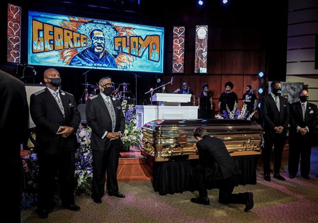 Minneapolis Mayor Jacob Frey kneels by the casket of George Floyd before a memorial service at North Central University, Thursday, June 4, 2020, in Minneapolis. Floyd died on May 25 as a Minneapolis police officer pressed his knee into his neck, ignoring his cries and bystander shouts until he eventually stopped moving. (AP Photo/Bebeto Matthews)