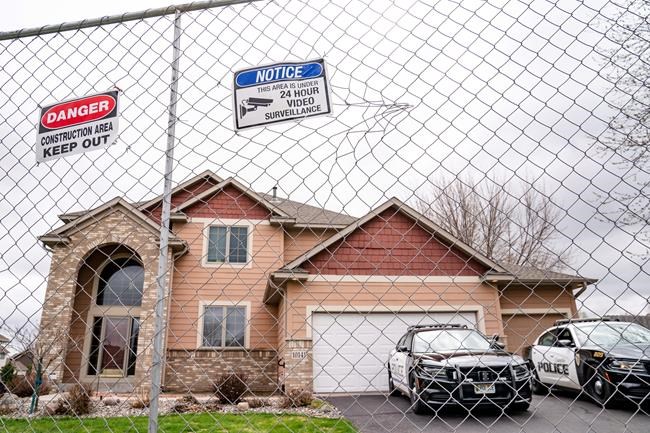 Fencing and concrete barriers surround the home of former Brooklyn Center police officer Kim Potter as local police guard her residence, Wednesday, April 14, 2021, in Champlin, Minn. A prosecutor said Wednesday that he will charge Potter, a white former suburban Minneapolis police officer with second-degree manslaughter for killing 20-year-old Black motorist Daunte Wright in a shooting that ignited days of unrest and clashes between protesters and police. (AP Photo/John Minchillo)