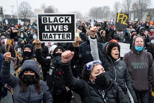 Demonstrators march to Brooklyn Center Police Department to protest the fatal shooting of Daunte Wright during a traffic stop, Tuesday, April 13, 2021, in Brooklyn Center, Minn. (AP Photo/John Minchillo)