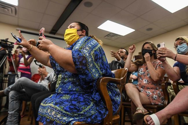 People react to Petal Mayor Hal Marx at a special board of aldermen meeting, Thursday, May 28, 2020, in Petal, Miss., over comments Marx made about the death of Minneapolis man George Floyd on social media. (Cam Bonelli/Hattiesburg American via AP)