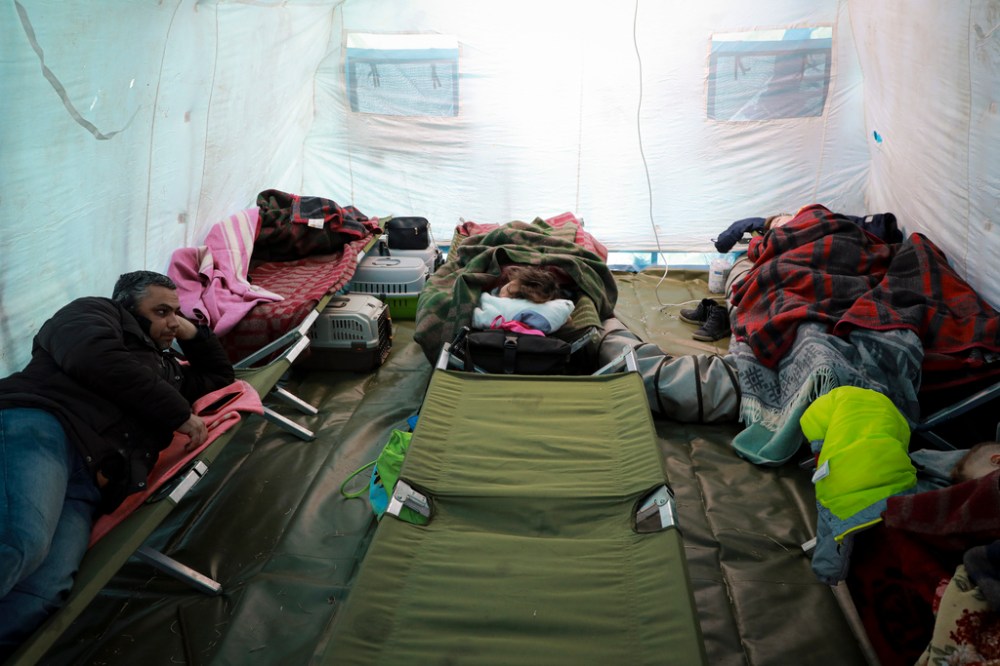 CP
Refugees from Ukraine sleep in a tent at the Moldovan-Ukrainian border, in Palalanca, Moldova. Thousands of Ukrainians are fleeing from war by crossing their borders to the west in search of safety. (AP Photo/Aurel Obreja)