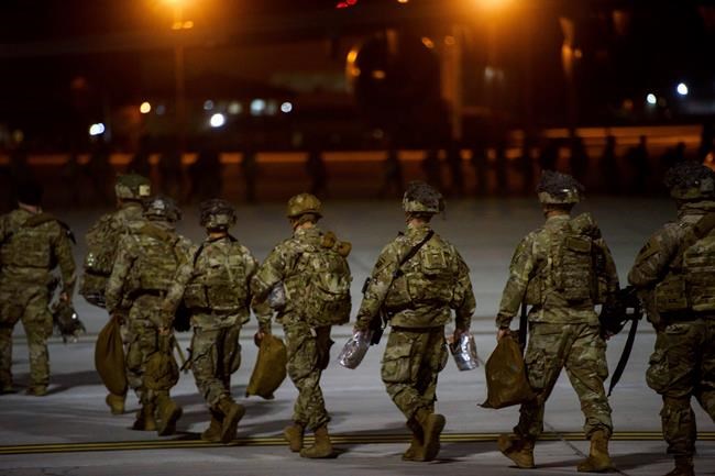 FILE - In this Wednesday, Jan. 1, 2020, file photo, U.S. Army soldiers from the 82nd Airborne board a C-17 aircraft at Fort Bragg, N.C., to be deployed to the Middle East. In addition to these troops, the United States is sending nearly 3,000 more soldiers to the Mideast as reinforcements in the volatile aftermath of the killing of Iranian Gen. Qassem Soleimani, defense officials said Friday, Jan. 3. (Melissa Sue Gerrits/The Fayetteville Observer via AP, File)