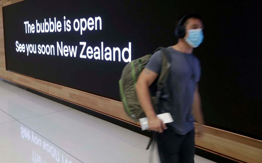 Rick Rycroft / The Associated Press files
A passenger prepares at Sydney Airport, in Sydney, Australia, last month to catch a flight to New Zealand as the much-anticipated travel bubble between Australia and New Zealand opens.