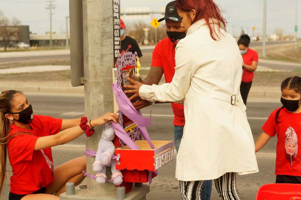 The family of Eishia Hudson rebuilt a memorial at the intersection of Fermor Avenue and Lagimodiere Boulevard on Sunday evening. A previous memorial to the teen who was fatally shot by a Winnipeg police officer near the intersection was removed. (Danielle Da Silva / Winnipeg Free Press)