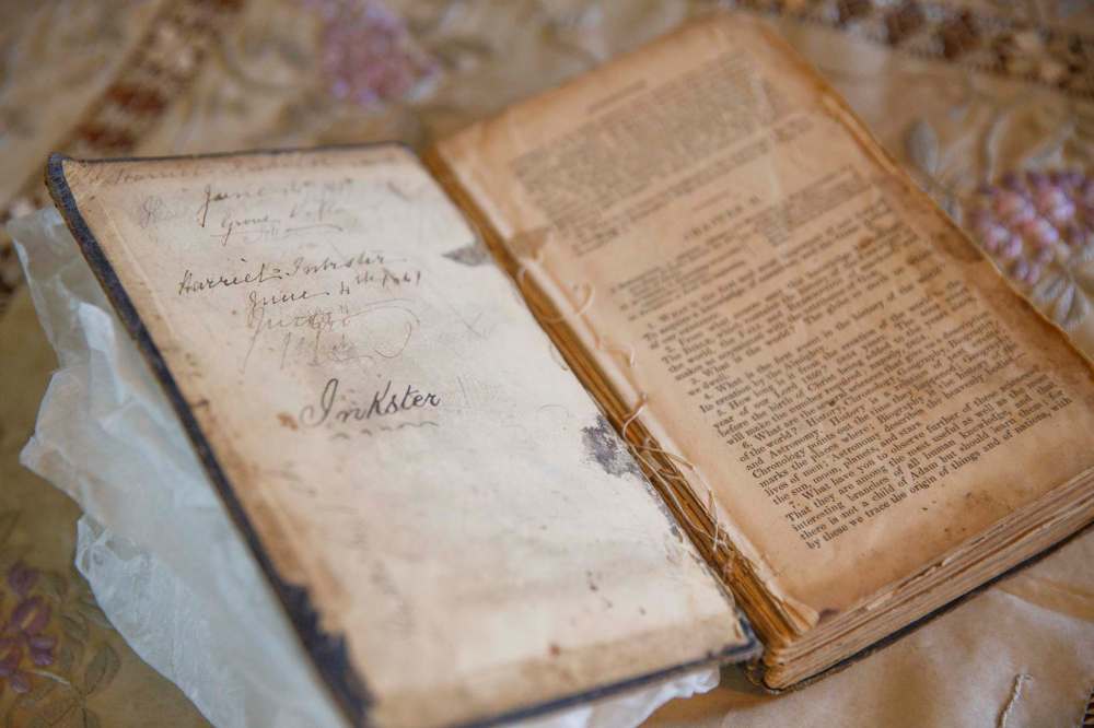 A book of Harriet Inkster’s with a date of June 4, 1867, written on the inside cover. Pieces of embroidery thread and flowers were pressed between its pages. (Mike Deal / Winnipeg Free Press)
