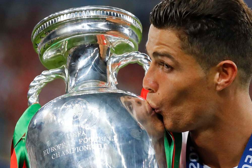 Frank Augstein / The Associated Press files
Cristiano Ronaldo kisses the trophy after Portugal won the Euro 2016 Championship. Portugal, and 23 other European nations, begin the quest for European football supremacy today.