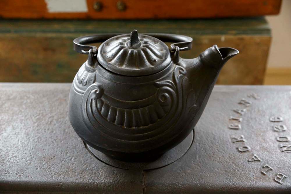 A large, very heavy, cast iron tea kettle that would have provided enough tea for the whole house and any visitors who might drop in. (Mike Deal / Winnipeg Free Press)