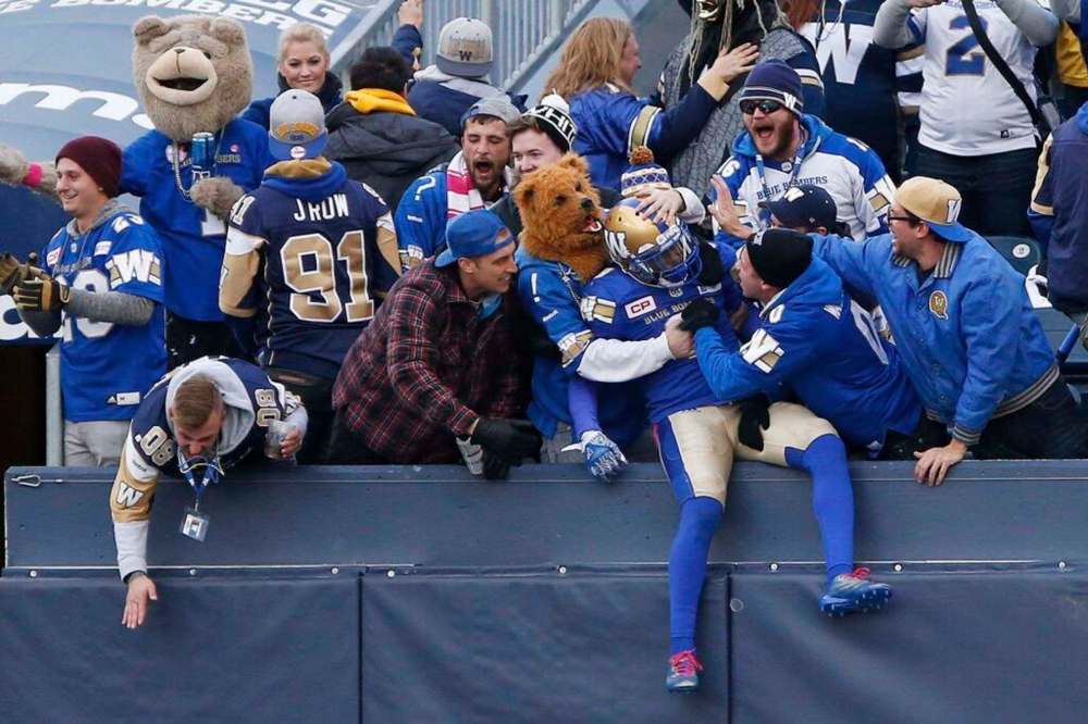 Winnipeg Blue Bombers' fans celebrate during CFL game action against the B.C. Lions, in Winnipeg in 2017. THE CANADIAN PRESS FILES/John Woods