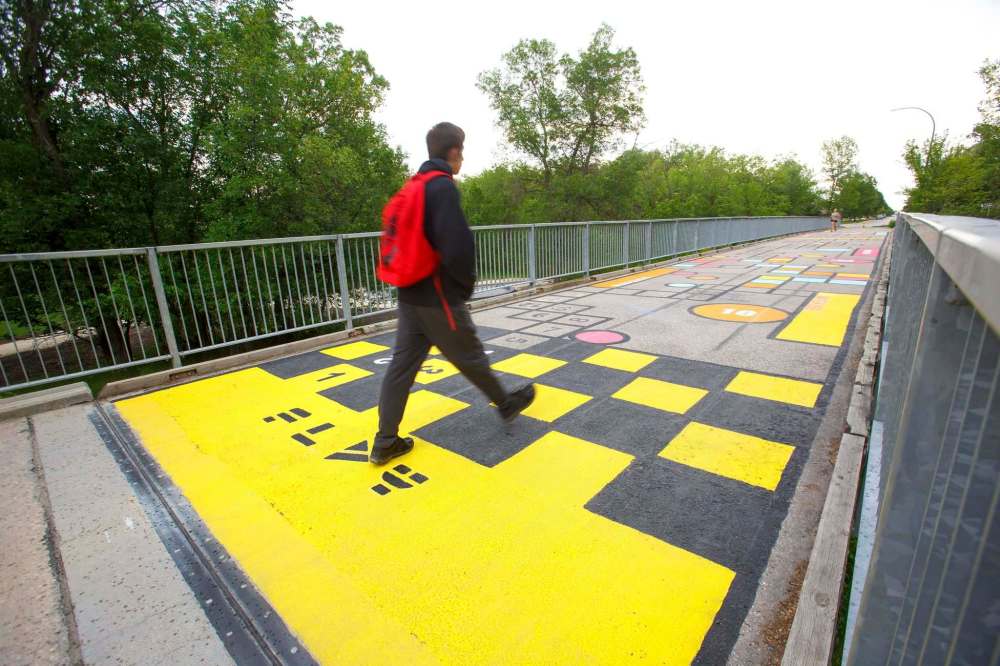 Five pedestrian bridges look a lot brighter this week thanks to a fresh coat of paint and creativity. (Mike Deal / Winnipeg Free Press)