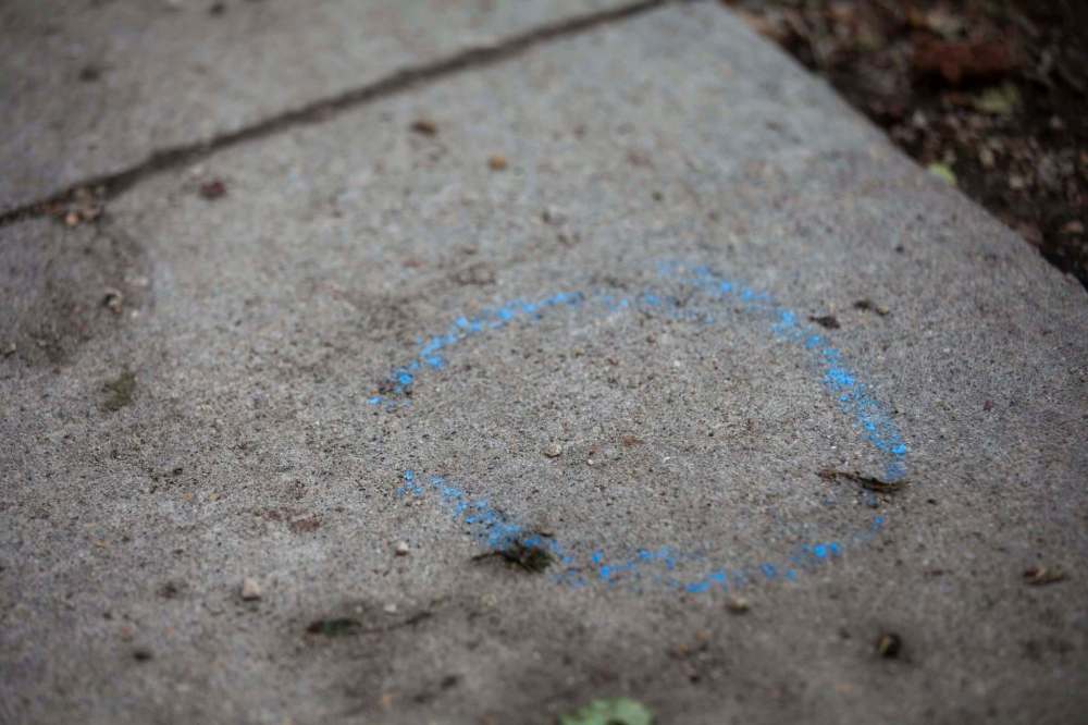 Blue chalk marks a spot where evidence was found during the police investigation. (Daniel Crump / Winnipeg Free Press)