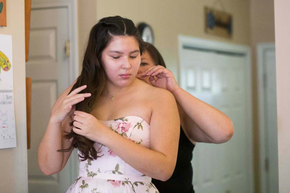 MIKAELA MACKENZIE / WINNIPEG FREE PRESS
Abraham’s sister, Paula Savoie, fastens a necklace