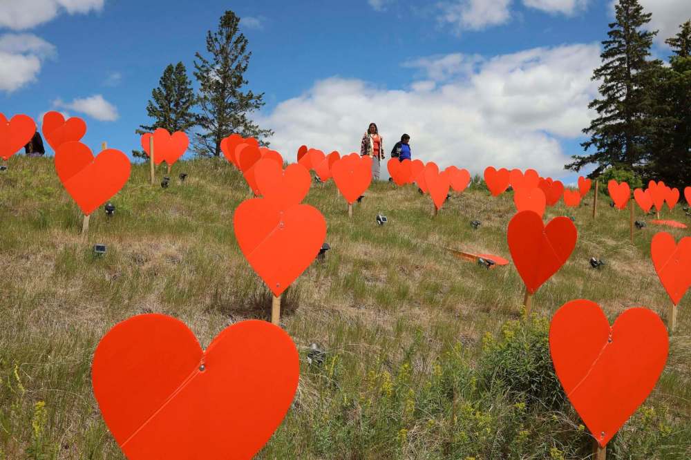 Tim Smith / The Brandon Sun
Guests look over the orange hearts placed on the site of the former Brandon Indian Residential School, symbolizing the 104 children who died at the institution.
