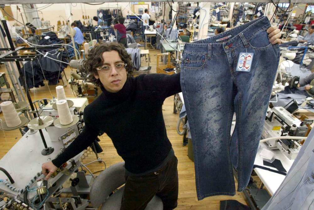 JOE BRYKSA / FREE PRESS FILES
McCoshen shows off a pair of Brawd jeans at his manufacturing plant on Notre Dame Avenue in 2002.