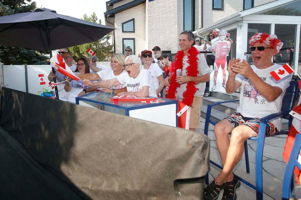 Family and friends of triathlete Tyler Mislawchuk gather at his parents’ home in Oak Bluff to watch him race at the Tokyo Olympics Sunday. (John Woods / Winnipeg Free Press)