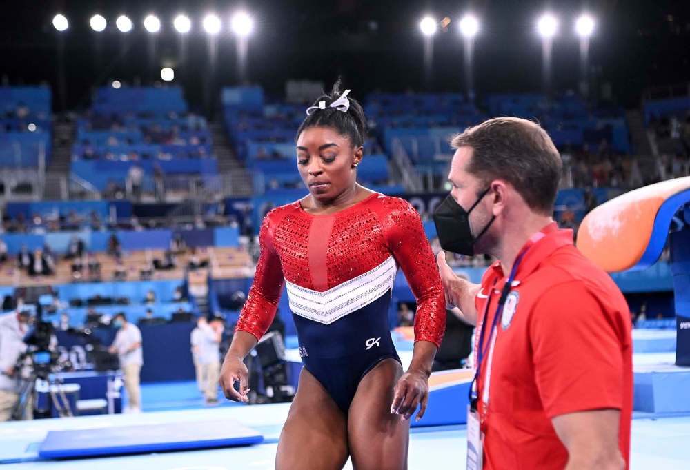 Wally Skalij / TNS
U.S. gymnast Simone Biles is consoled after competing on the vault and withdrawing from competition due to an injury in the women's team final at the 2020 Tokyo Olympics on Tuesday, in Tokyo, Japan.