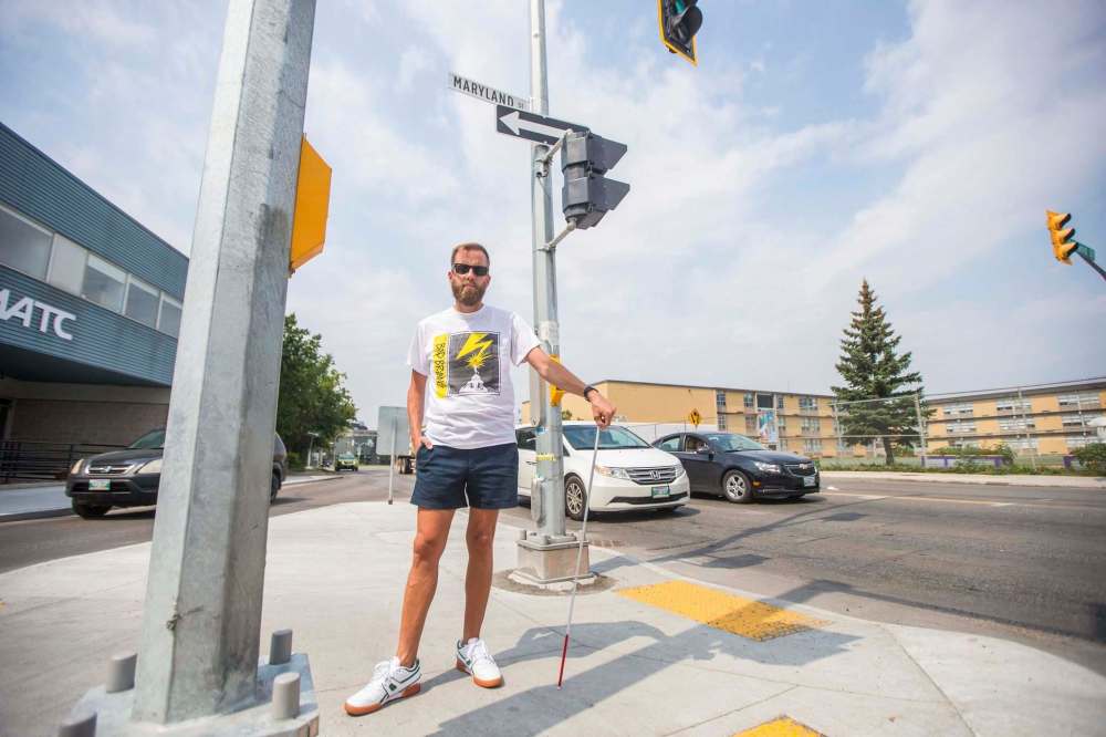 MIKAELA MACKENZIE / WINNIPEG FREE PRESS
Tyler Sneesby poses for a portrait at the intersection of Broadway and Maryland, where the audio sounds for visually impaired folks were mixed up (and telling the person to walk into traffic instead of in the direction of traffic) for months, in Winnipeg on Wednesday, July 28, 2021. For Kevin story.Winnipeg Free Press 2021.