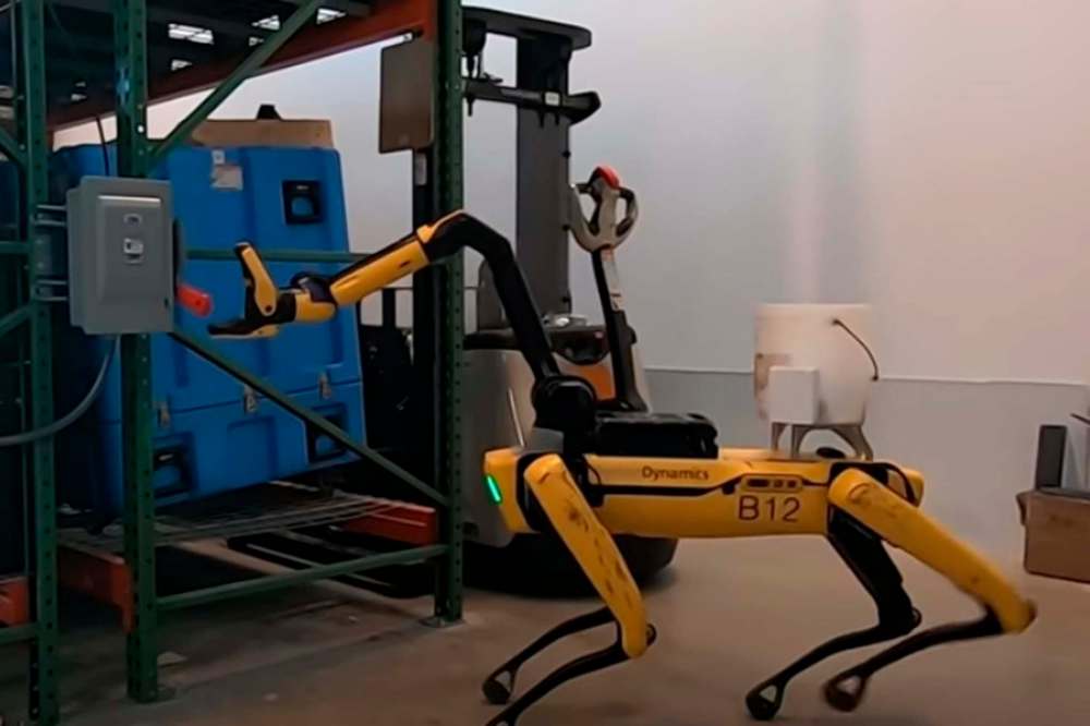 The robotic dog "Spot" is seen operating a switch in a video made by its manufacturer, Boston Dynamics. (YouTube)