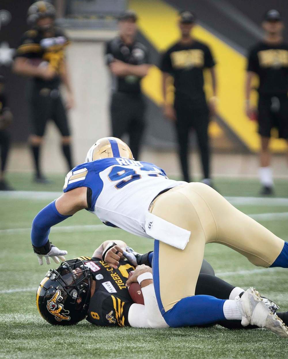 Bombers defensive lineman Craig Roh goes over Jeremiah Masoli on July 26, 2019. Masoli suffered a serious knee injury, which included a torn anterior cruciate ligament, on the play, ending his season. (Peter Power / The Canadian Press files)