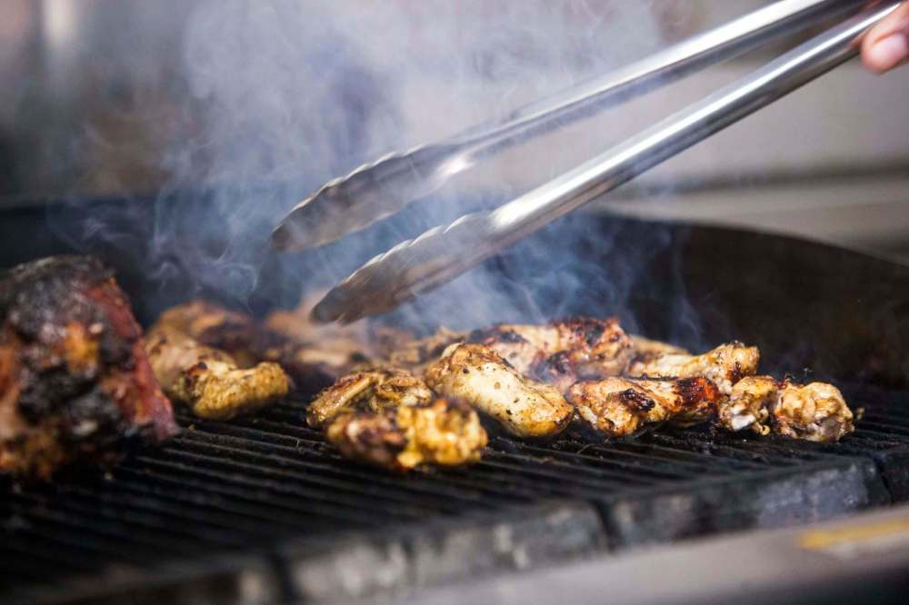 Jerk wings are on the menu at Gladys Caribbean Kitchen on Sargent Avenue. (Mikaela MacKenzie / Winnipeg Free Press)