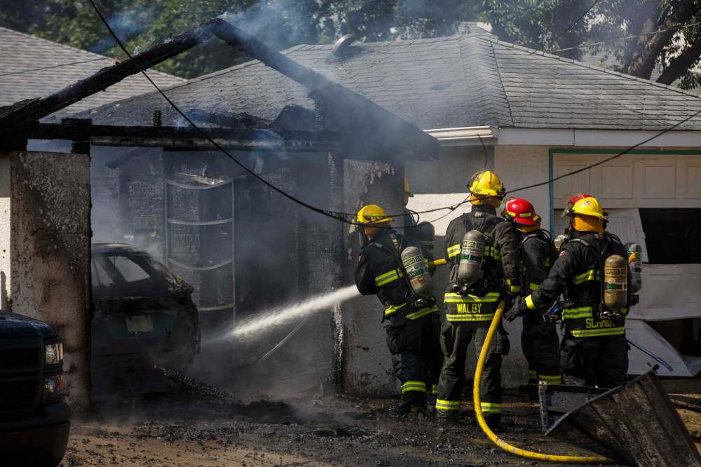 MIKE DEAL / WINNIPEG FREE PRESS
Winnipeg firefigther crews battle a garage fire at 366 Carpathia road that also destroyed a vehicle as well as damaged an adjacent garage last summer.