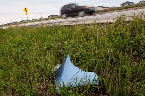Daniel Crump / Winnipeg Free Press. A piece of a bumper and some marks on the highway near the scene of a serious two-vehicle collision on the Perimeter Highway, approximately one kilometre west of St. Anne&rsquo;s Road. Three occupants of a minivan, one 26-year-old male driver and a 26-year-old female passenger, both of Steinbach and a 63-year-old female passenger, from Germany, were pronounced dead at the scene. August 21, 2021.