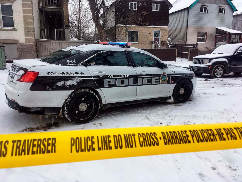 BORIS MINKEVICH / WINNIPEG FREE PRESS
Winnipeg Police Service sit on the crime scene where someone was shot on Aikins Street near Mountain Ave. The shooting took place at about 4 a.m. at a home in the 300 block of Aikins Street. WPS. Police Car. Squad. Tape. Dec. 16, 2017