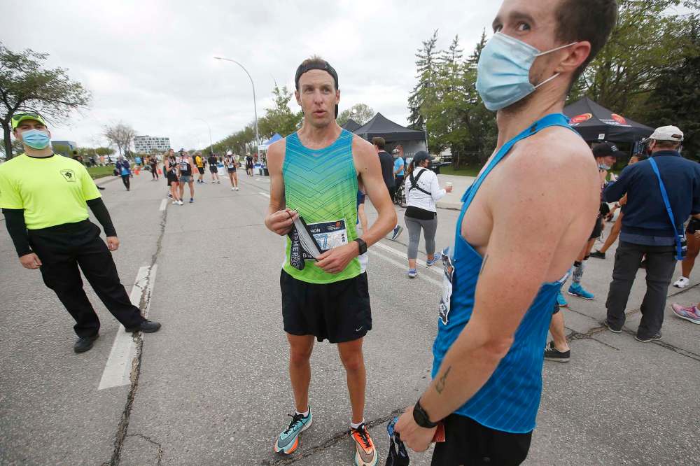 JOHN WOODS / WINNIPEG FREE PRESS
Brian Walker, centre, was the first man to cross the marathon finish line at the Manitoba Marathon.