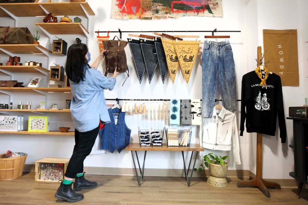 Megan staging some unique wares: clothing, candles, books, records, leather goods. (Ruth Bonneville / Winnipeg Free Press)