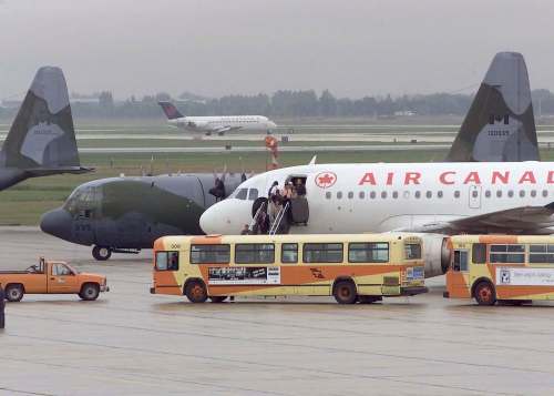 17 WING PHOTO
Diverted Air Canada passenger planes sit among military aircraft on the tarmac at the 17 Wing airfield on Sept. 12, 2001.