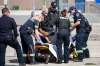 DANIEL CRUMP / WINNIPEG FREE PRESS FILES
Winnipeg Police officers and members of the Winnipeg Fire Paramedic Service tend to a handcuffed and hooded person.