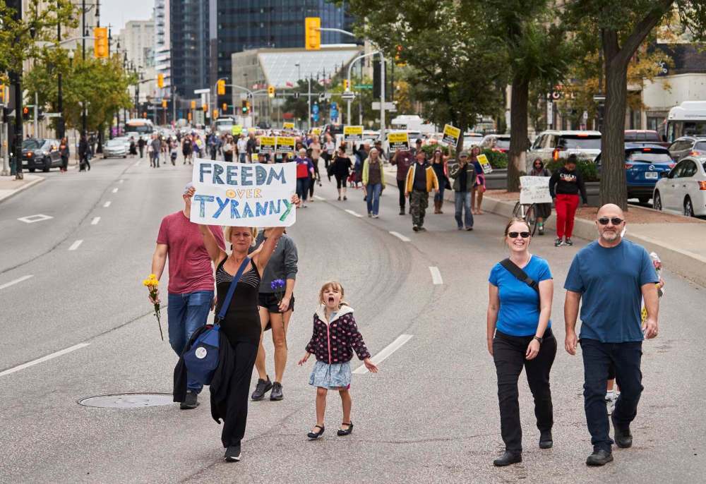 Protesters marched from the Manitoba Legislative Building to Winnipeg city hall on Sept. 13 after the rally was moved from HSC. (David Lipnowski / The Canadian Press files)