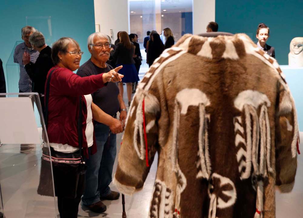 WAYNE GLOWACKI / FREE PRESS FILES
Peter and Elizabeth Awa, visitors from the community of Iglulik, look at a replica of coat worn by Peter’s grandfather, who was a shaman, as part of the Our Land: Contemporary Art From The Arctic exhibition in 2016.