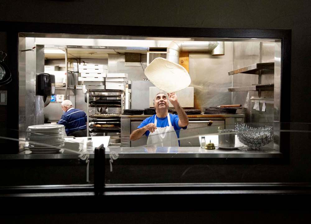 Gerry Lomonaco spins pizza dough in the same spot he’s been spinning dough since opening the spot in 1985.