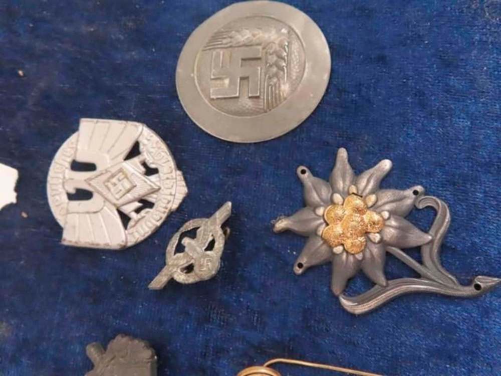 MCSHERRY AUCTION SERVICES
The Nazi paraphernalia includes various pins.