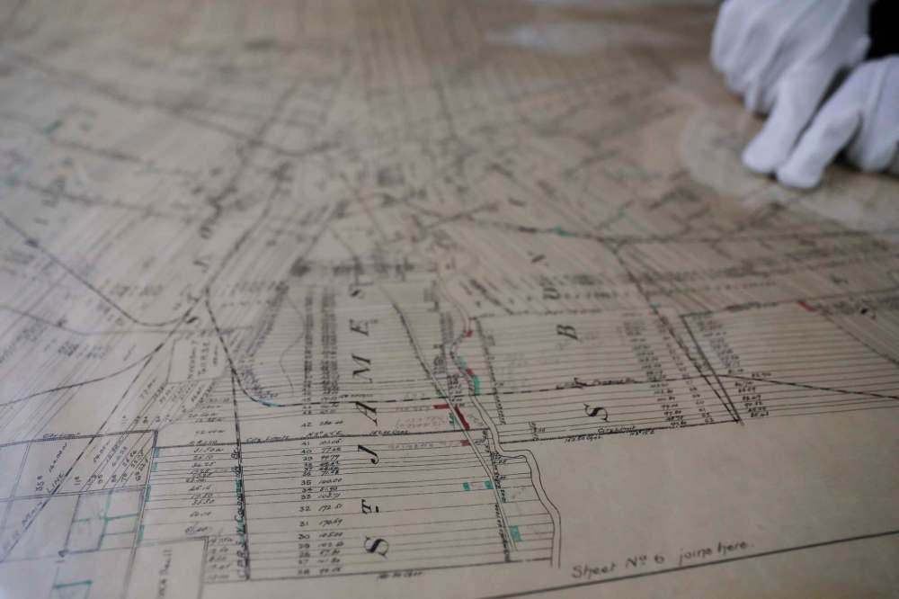 Some items arrived at the museum with little or no backstory, including a set of parish lot survey maps from 1894, printed on cotton canvas. (Jessica Lee / Winnipeg Free Press)