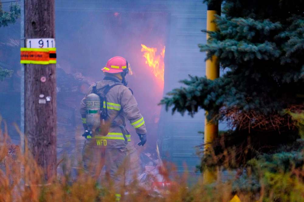The fire at the former Nygard warehouse on Notre Dame Avenue is expected to take all day to put out. (Mike Deal / Winnipeg Free Press)