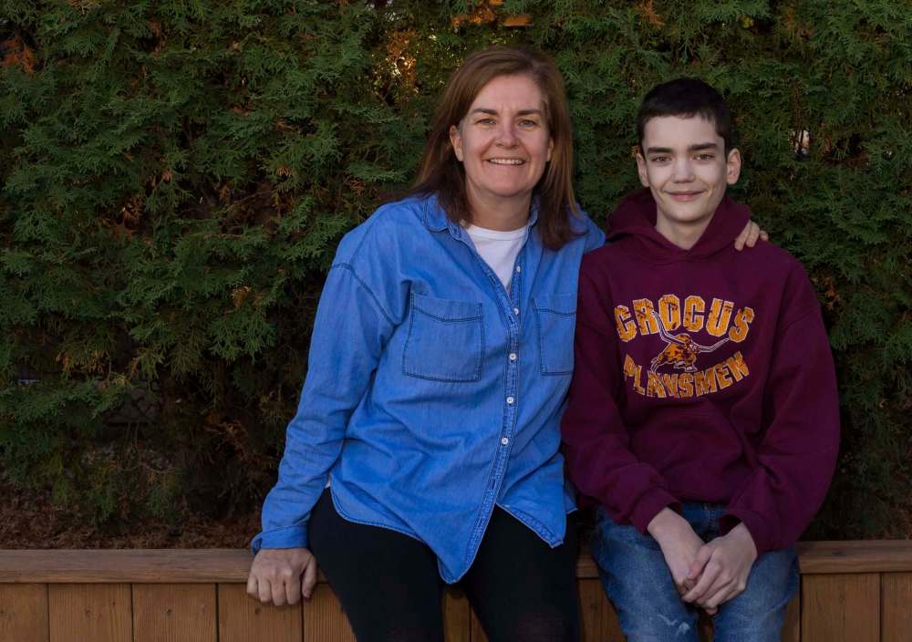 Meredith Walker, left, and her son Morgan, 16, sit in their back yard Thursday. (Chelsea Kemp / Brandon Sun)