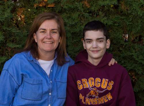 Meredith Walker, left, and her son Morgan, 16, sit in their back yard Thursday. (Chelsea Kemp / Brandon Sun)