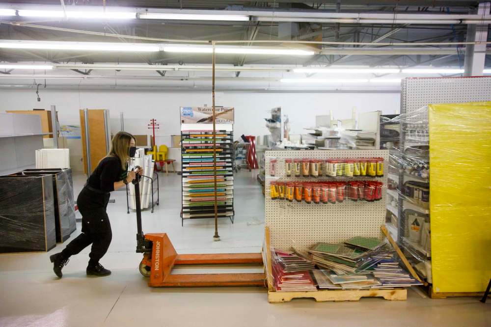 MIKE DEAL / WINNIPEG FREE PRESS
Employee Haley Bean moves a display of paints in the new retail area of the new location.