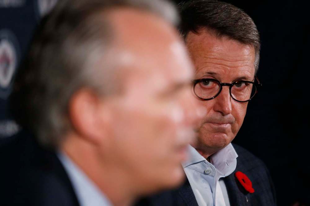 Winnipeg Jets executive chairman and governor Mark Chipman (right) listens as Cheveldayoff speaks to media Tuesday. (John Woods / Winnipeg Free Press)