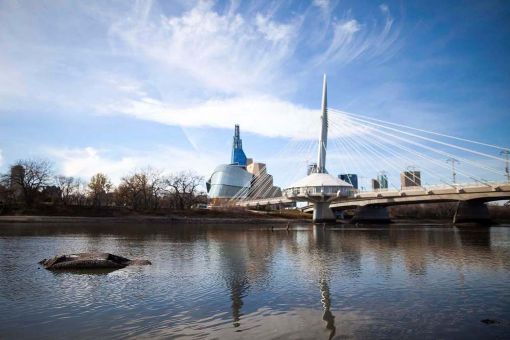 Low water levels on the Red River have revealed the wreckage of an old car near the Provencher bridge by the Forks. (Daniel Crump / Winnipeg Free Press)