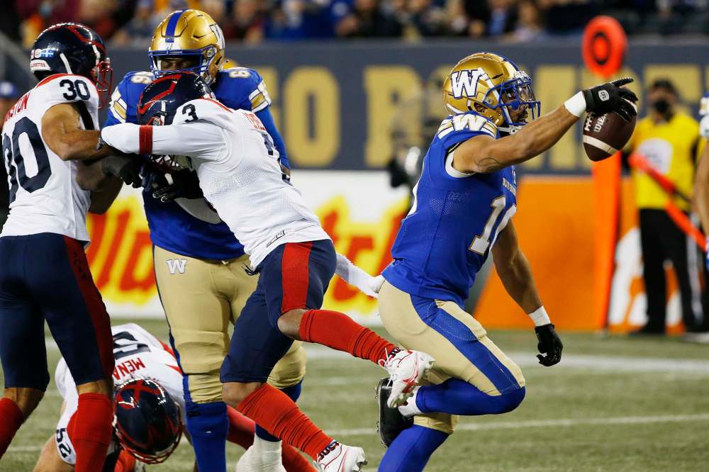 Winnipeg Blue Bombers' Nic Demski (10) celebrates his touchdown against the Montreal Alouettes during the first half of CFL action in Winnipeg Saturday, November 6, 2021. (John Woods / The Canadian Press)