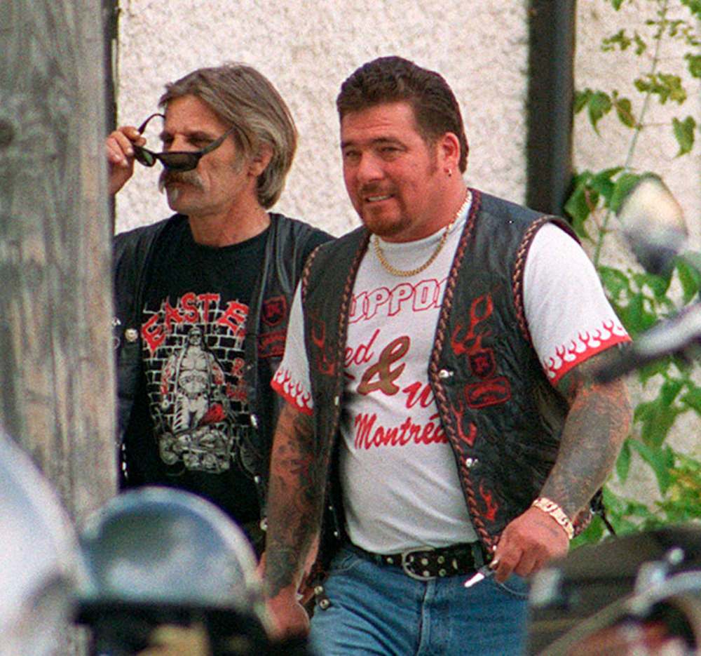 Hells Angels member Jack Shore, left, outside the former Spartan's clubhouse in East Kildonan. (Free Press file.)