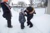 Tiffany Munro puts on a mask for her son Maverick, 5, as he heads to school Monday morning. (Mike Deal / Winnipeg Free Press)