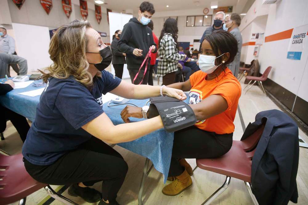 Kelly Lambkin, manager of community engagement for Diabetes Canada, tests the blood pressure of Health Minister Audrey Gordon as she attends the final in a series of mobile diabetes testing clinics put on by Canadian Diabetes at the Maples Community Centre in Winnipeg on Sunday. JOHN WOODS / WINNIPEG FREE PRESS