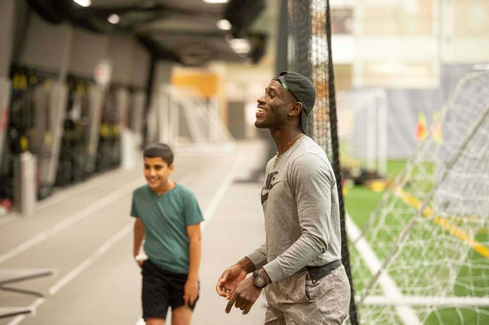 Mike Sudoma / Winnipeg Free PressRising Star founder Wilfred Sam-King shares a laugh with an athlete.