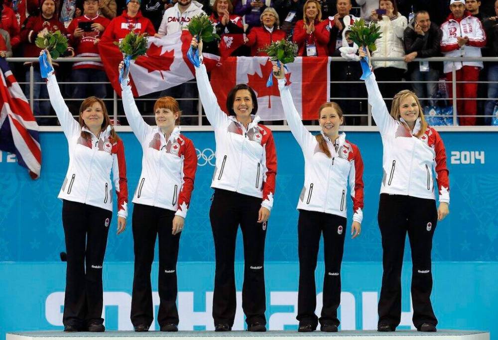 Kirsten Wall (from left), Dawn McEwen, Jill Officer, Kaitlyn Lawes and Jennifer Jones celebrate after winning the gold medal game against Sweden at the 2014 Winter Olympics. (Wong Maye-E / The Associated Press files)